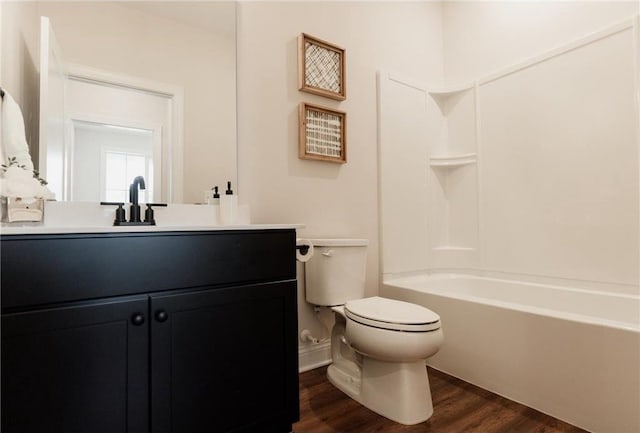 full bathroom with vanity, wood-type flooring, shower / bathtub combination, and toilet