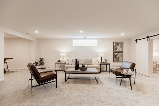 carpeted living room with a barn door