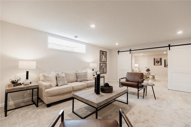 living room with a barn door and light carpet