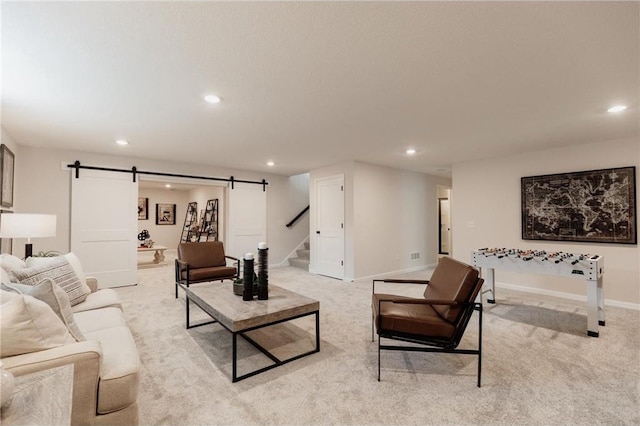 living room with a barn door and light carpet