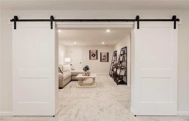 carpeted living room with a barn door