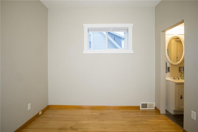 empty room with light hardwood / wood-style floors