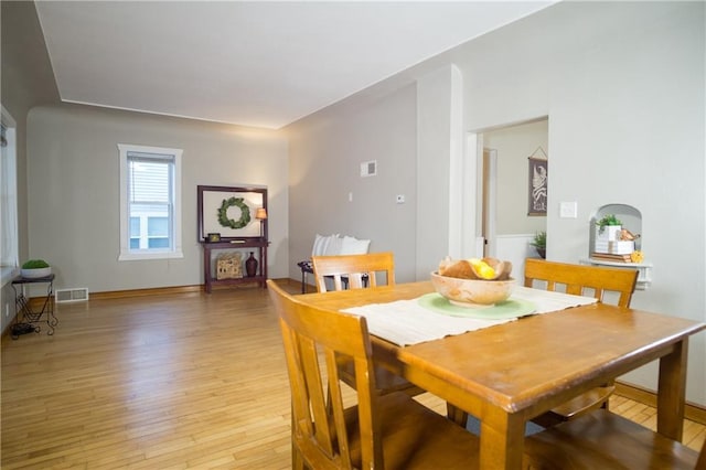 dining space with light hardwood / wood-style floors