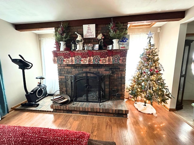 interior details featuring beam ceiling, a fireplace, and hardwood / wood-style flooring