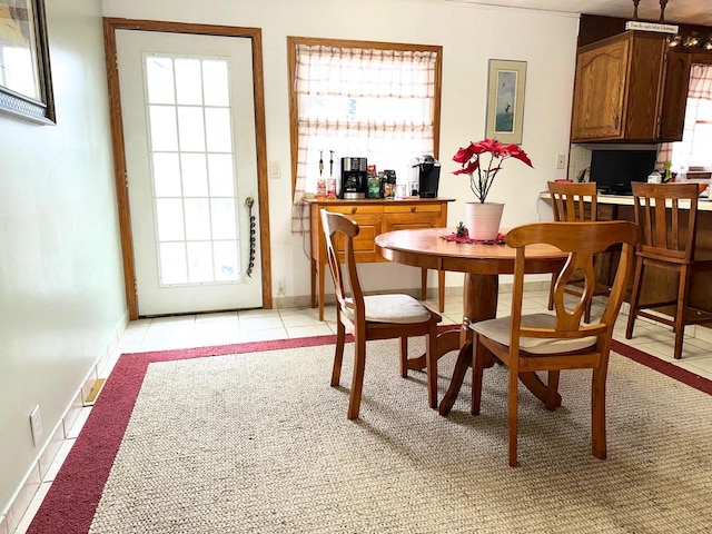 tiled dining room featuring a wealth of natural light