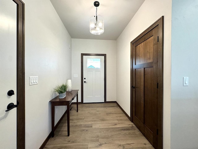 entryway featuring a notable chandelier and light hardwood / wood-style floors