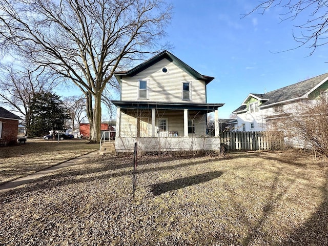 rear view of property featuring a porch