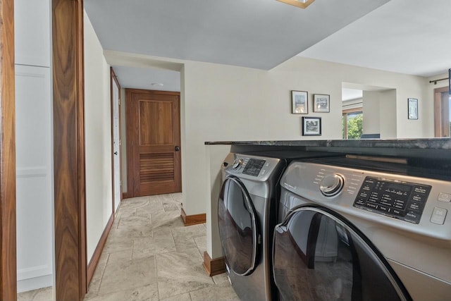 washroom with washing machine and clothes dryer