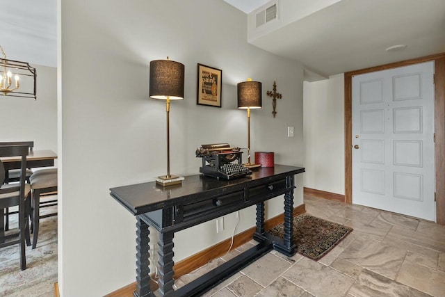 entryway with a chandelier