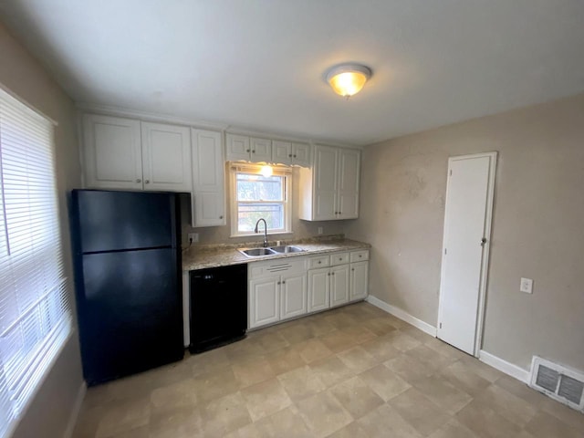 kitchen featuring white cabinets, sink, and black appliances