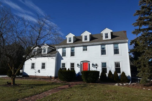 colonial inspired home with a front yard