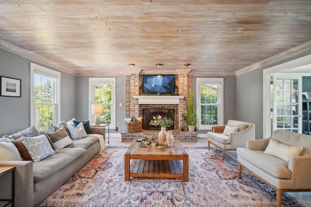 living room with light wood-type flooring, a brick fireplace, ornamental molding, and wood ceiling