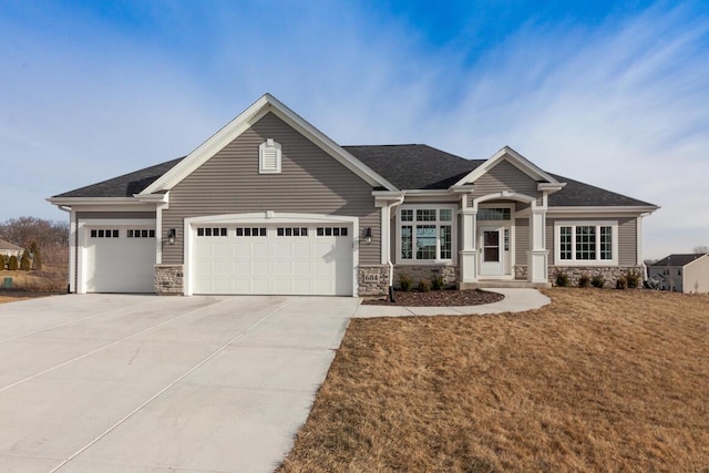 view of front of home featuring a garage and a front yard