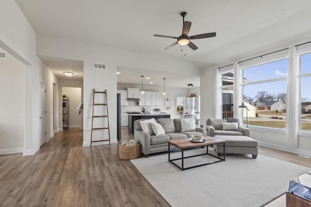 living room with ceiling fan and light hardwood / wood-style floors