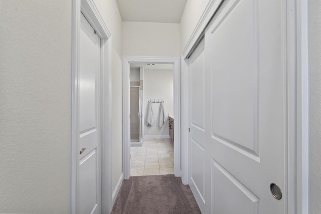 hallway with light colored carpet