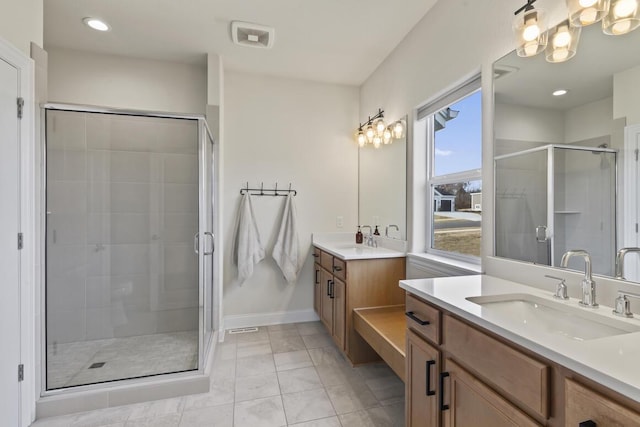 bathroom featuring tile patterned floors, vanity, and an enclosed shower