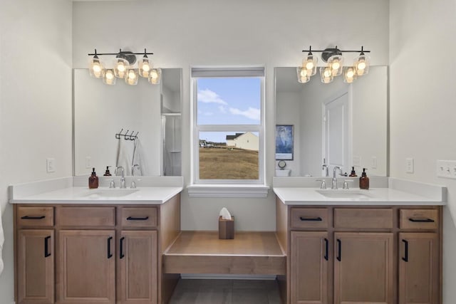 bathroom featuring walk in shower, vanity, and a wealth of natural light