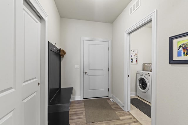 laundry area featuring washer / dryer and light wood-type flooring