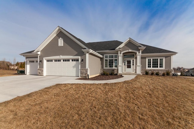 view of front of property featuring a garage and a front lawn