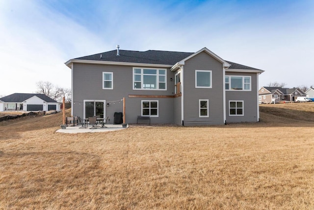 rear view of property featuring a yard and a patio