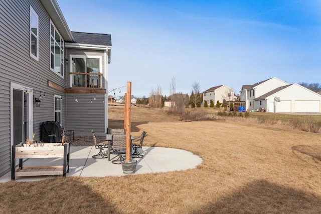 view of yard featuring a patio area and a balcony