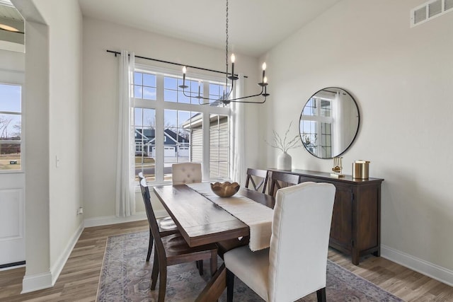 dining space featuring a chandelier and hardwood / wood-style flooring