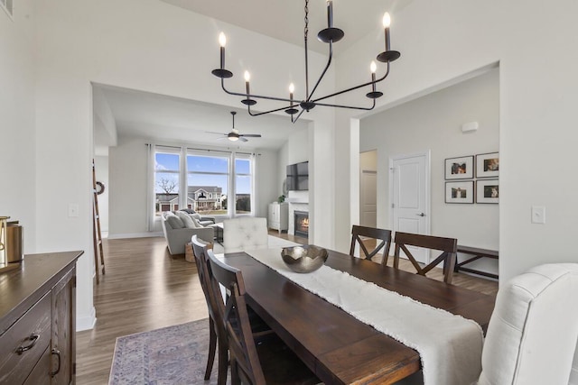 dining area featuring ceiling fan and dark hardwood / wood-style flooring