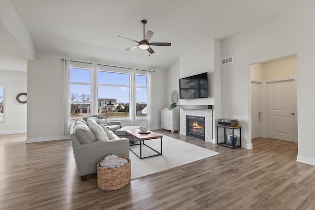 living room featuring ceiling fan and hardwood / wood-style floors