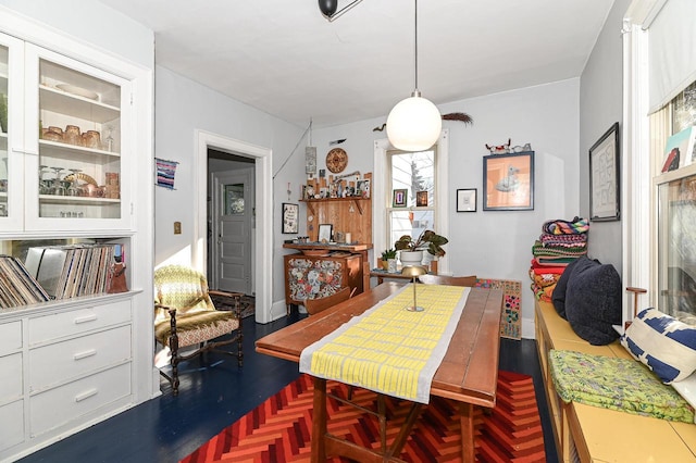 dining area featuring dark parquet flooring