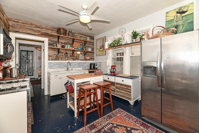 kitchen with white cabinets, ceiling fan, and stainless steel refrigerator with ice dispenser