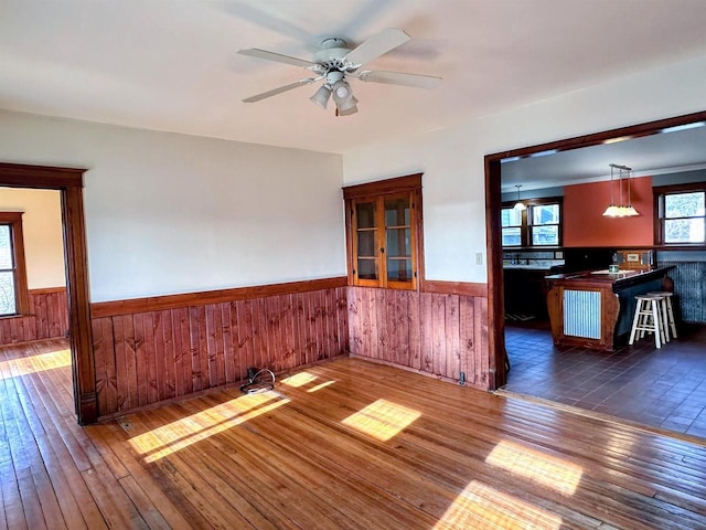 unfurnished living room with ceiling fan and dark wood-type flooring