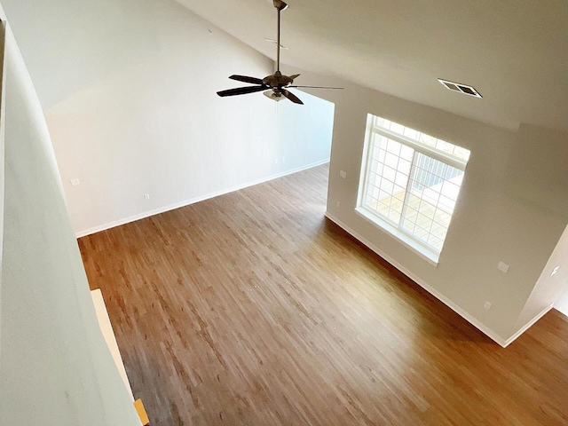 unfurnished living room featuring lofted ceiling, ceiling fan, and light wood-type flooring