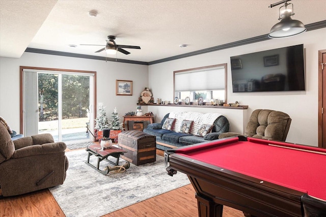 recreation room featuring a textured ceiling, hardwood / wood-style flooring, ceiling fan, and billiards