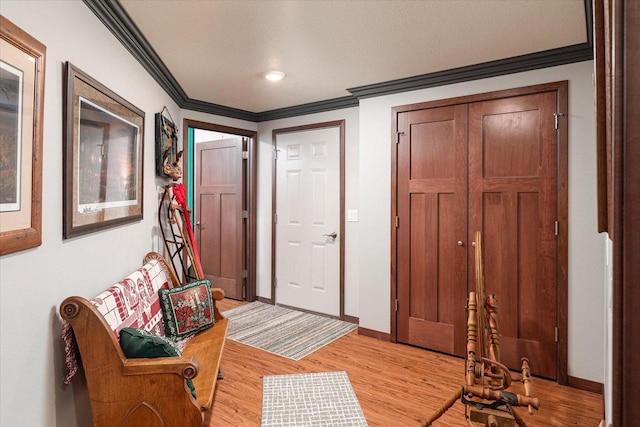 foyer entrance featuring light hardwood / wood-style flooring and ornamental molding