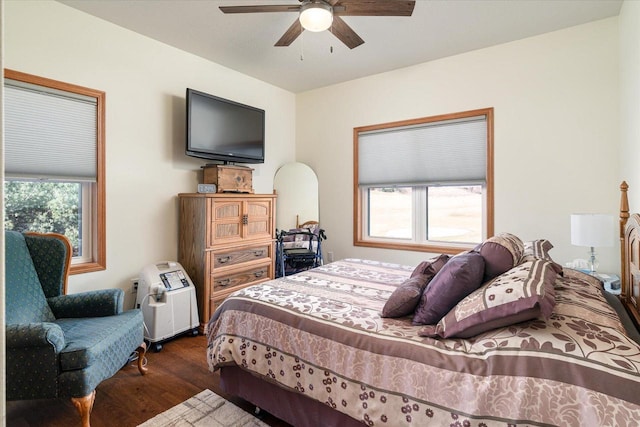 bedroom with ceiling fan and dark wood-type flooring