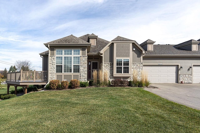 prairie-style house featuring a front lawn, a garage, and a deck