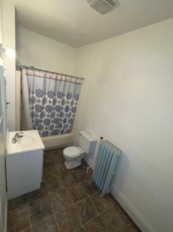 full bathroom with shower / bath combination with curtain, toilet, radiator heating unit, and vanity