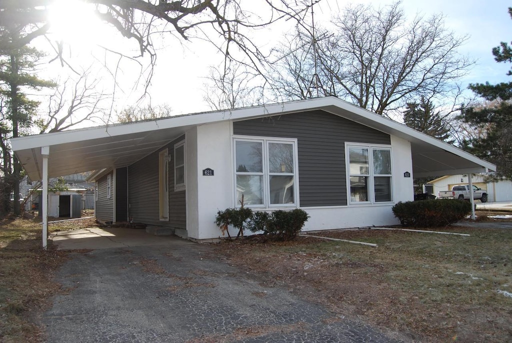 view of property exterior featuring a carport