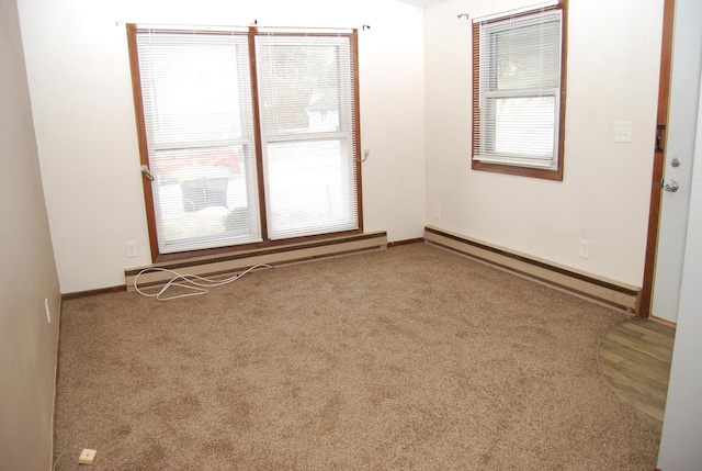 carpeted spare room with baseboard heating