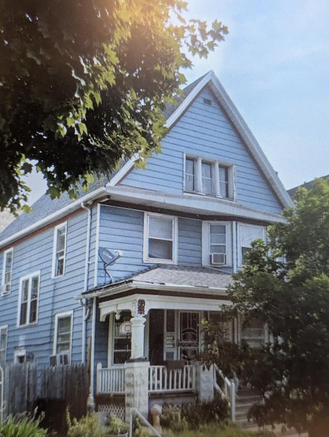 view of front of property featuring covered porch and cooling unit