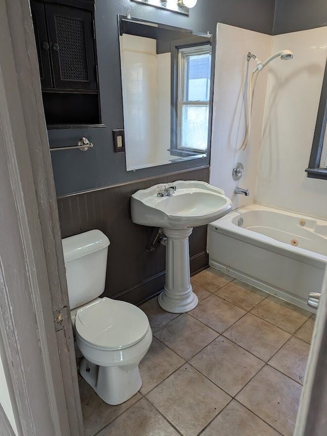 bathroom featuring tile patterned floors, toilet, and bathtub / shower combination