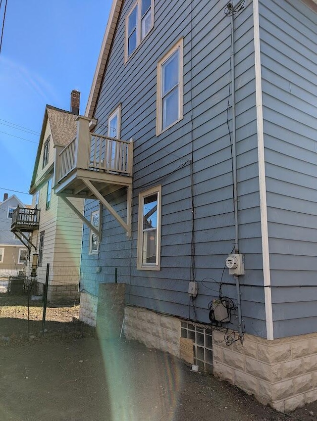 view of side of property with a balcony