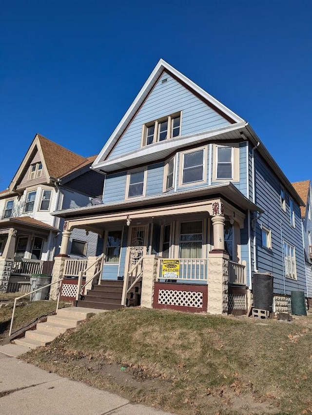 view of front facade with covered porch and a front yard