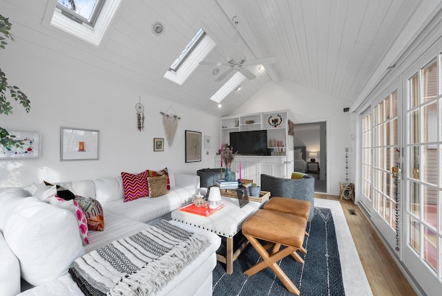 living room featuring ceiling fan, hardwood / wood-style floors, wooden ceiling, and lofted ceiling with skylight