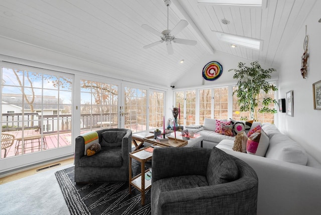 sunroom / solarium featuring a wealth of natural light, vaulted ceiling with beams, ceiling fan, and wood ceiling