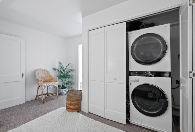 laundry area with stacked washer / dryer and light carpet