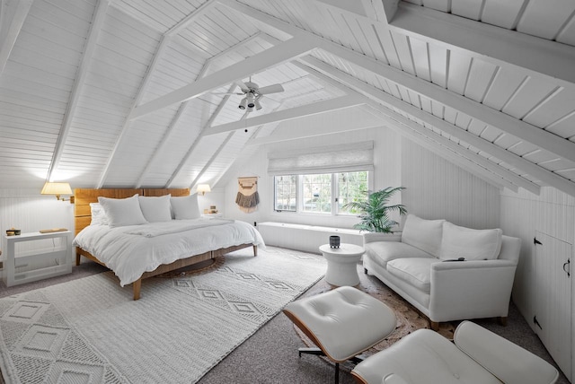 carpeted bedroom with lofted ceiling with beams, wood walls, and ceiling fan