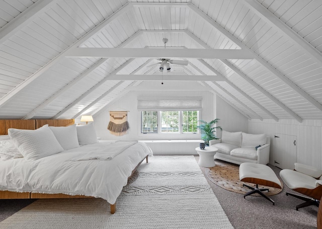 carpeted bedroom featuring wooden walls, ceiling fan, and lofted ceiling with beams