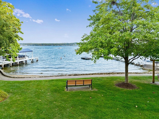 exterior space featuring a lawn and a water view