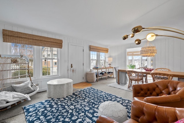 living room with carpet flooring and wood walls